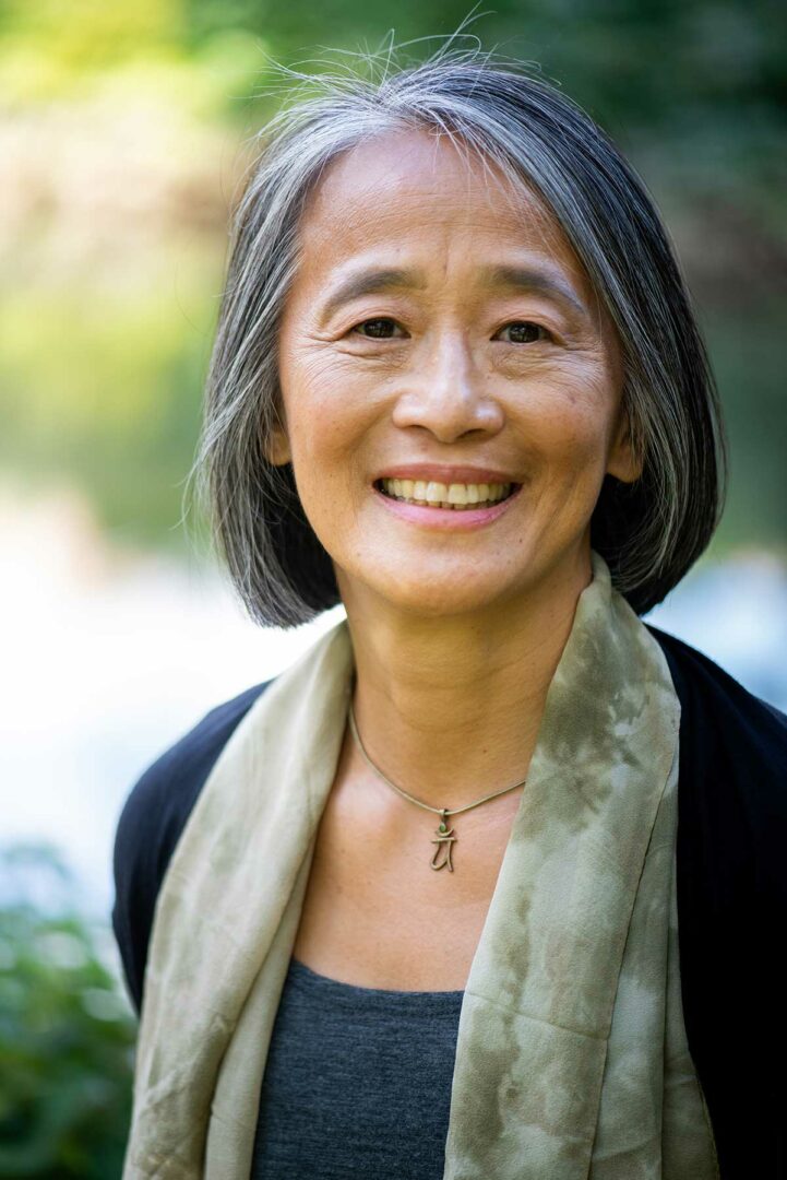 A woman with grey hair smiling for the camera.